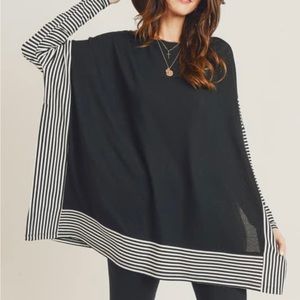 Black poncho with black & white stripe trim and sleeves.